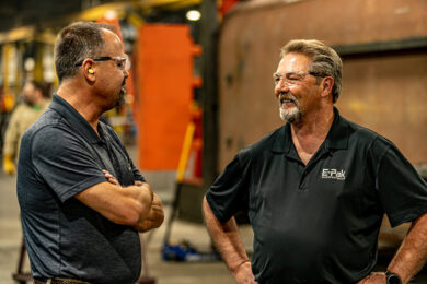 two men talking in shop